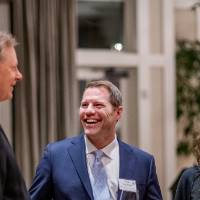 A group of four people talking to each other.